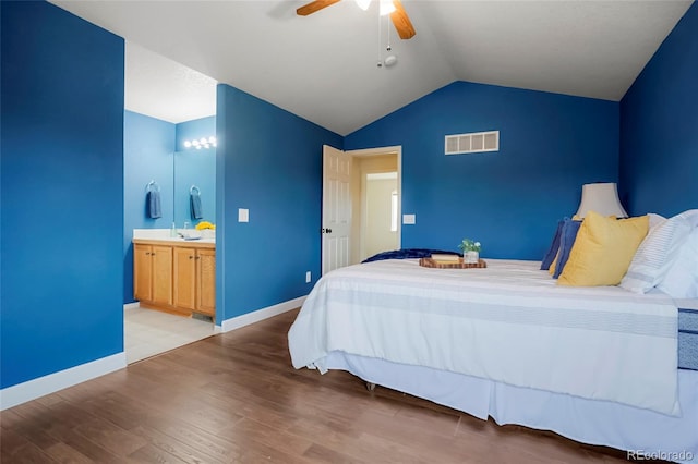 4873 Eckert St, Castle Rock, CO 80104 - bedroom featuring vaulted ceiling, wood finished floors, baseboards, ceiling fan, and connected bathroom