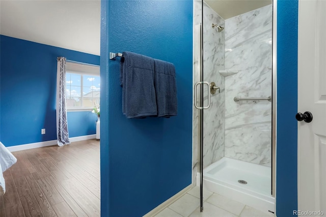 4873 Eckert St, Castle Rock, CO 80104 - bathroom featuring a marble finish shower, baseboards, and wood finished floors