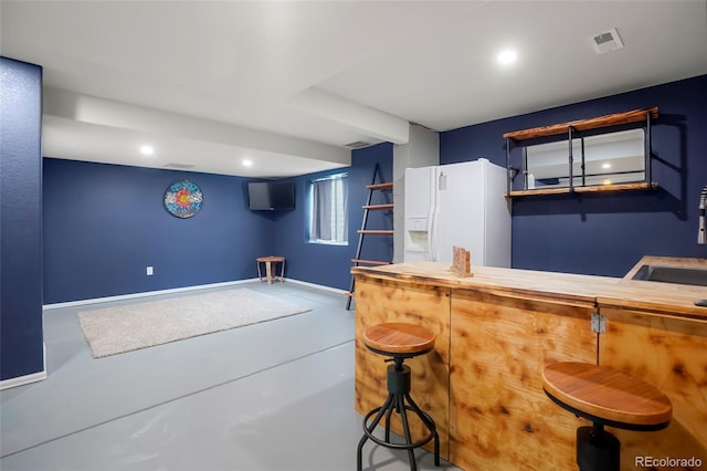 4873 Eckert St, Castle Rock, CO 80104 - indoor dry bar with white fridge with ice dispenser, baseboards, concrete floors, and recessed lighting