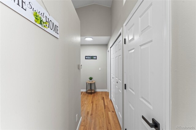 5965 Corinth Dr, Colorado Springs, CO 80923 - hall with light wood-style flooring, baseboards, and vaulted ceiling