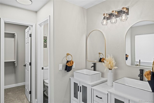 5965 Corinth Dr, Colorado Springs, CO 80923 - bathroom featuring toilet, vanity, and baseboards