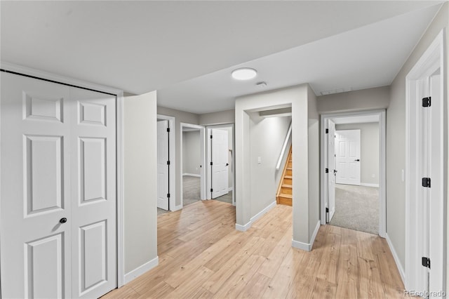 5965 Corinth Dr, Colorado Springs, CO 80923 - hallway featuring baseboards, light wood-style floors, and stairs