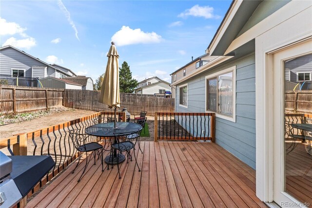 5965 Corinth Dr, Colorado Springs, CO 80923 - wooden deck featuring outdoor dining space and a fenced backyard