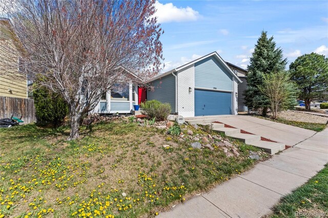 5965 Corinth Dr, Colorado Springs, CO 80923 - view of front of home featuring an attached garage, driveway, and fence