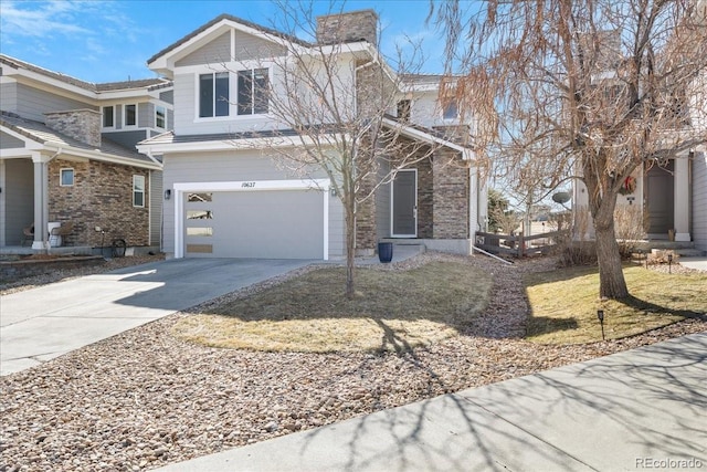 traditional home featuring a garage, brick siding, a chimney, and driveway