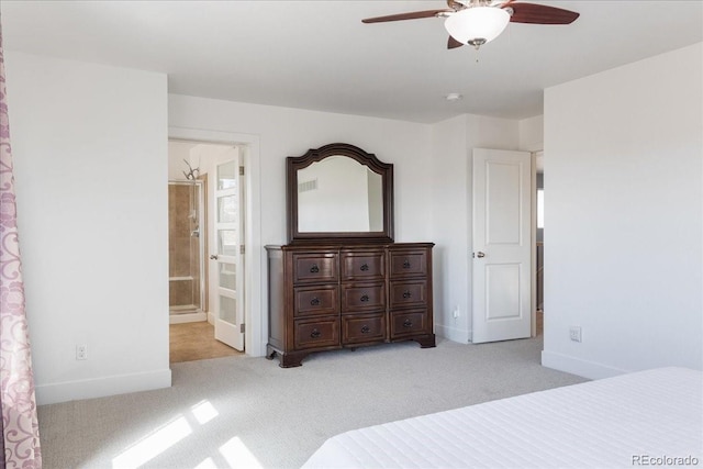 bedroom with connected bathroom, a ceiling fan, baseboards, and light carpet