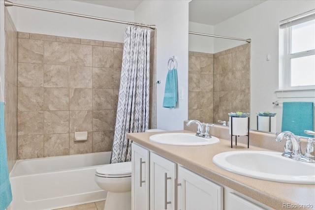 bathroom featuring a sink, shower / bathtub combination with curtain, toilet, and double vanity