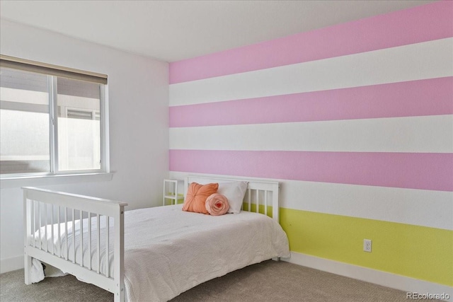 bedroom with baseboards and carpet