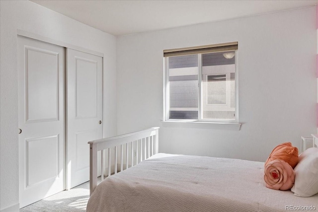 carpeted bedroom with a closet