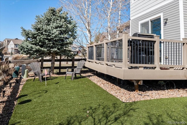 view of yard featuring a wooden deck and fence