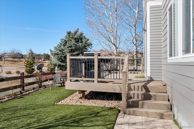 wooden deck with a yard and fence