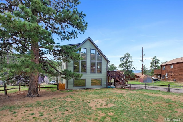 view of home's exterior featuring stairs and a deck