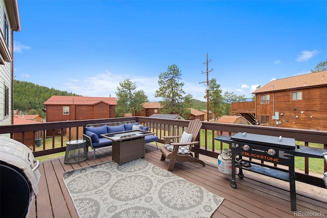 wooden terrace with an outdoor fire pit