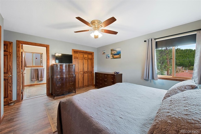 bedroom featuring wood finished floors, a ceiling fan, and baseboards