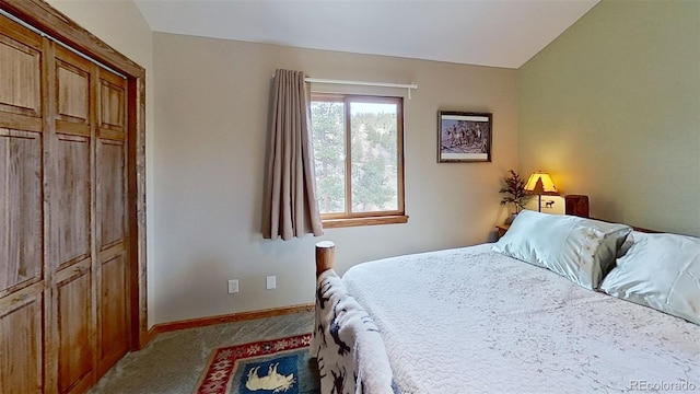 bedroom featuring carpet floors, baseboards, and vaulted ceiling