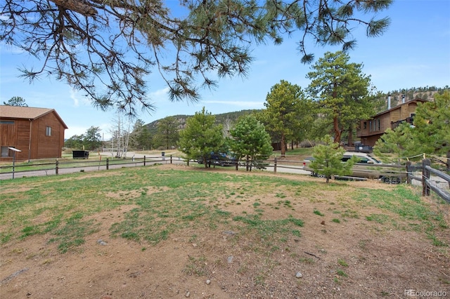view of yard with fence and a mountain view