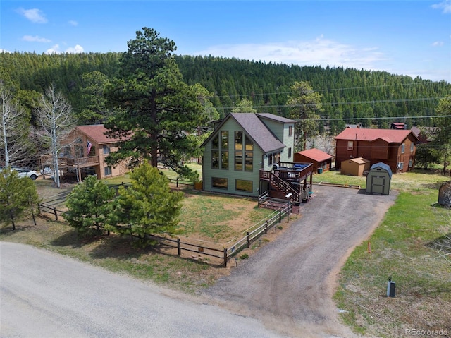 view from above of property with a heavily wooded area