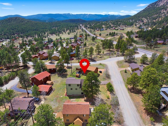 view of property location with mountains and nearby suburban area