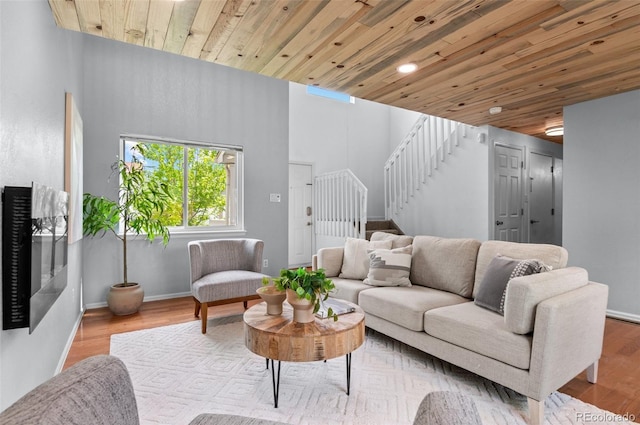 13245 Shoshone St, Denver, CO 80234 - living area featuring stairway, wood ceiling, wood finished floors, a high ceiling, and baseboards