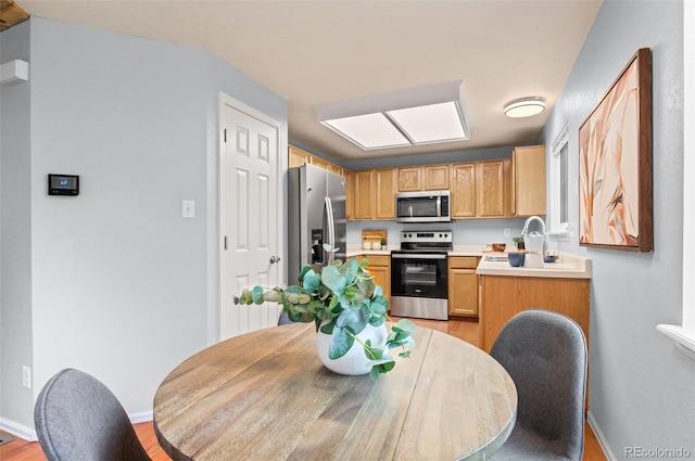 13245 Shoshone St, Denver, CO 80234 - kitchen with stainless steel appliances, light wood-style floors, light countertops, baseboards, and a sink