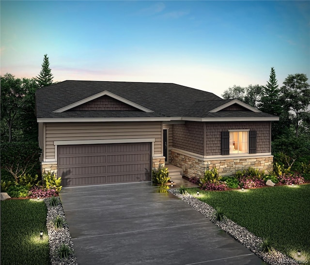 view of front of home featuring a yard and a garage