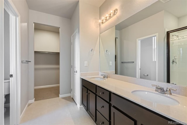 bathroom featuring an enclosed shower, tile patterned flooring, toilet, and vanity