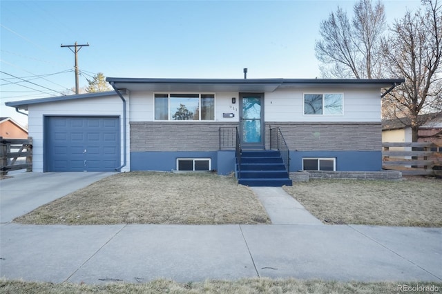 view of front of home with stone siding, concrete driveway, a garage, and fence