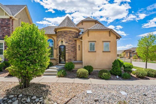 8913 Sunstone Dr, Colorado Springs, CO 80924 - view of front of home featuring stucco siding and stone siding
