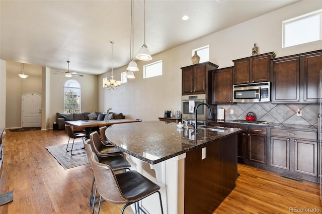 8913 Sunstone Dr, Colorado Springs, CO 80924 - kitchen with stainless steel appliances, a sink, plenty of natural light, and light wood-style floors