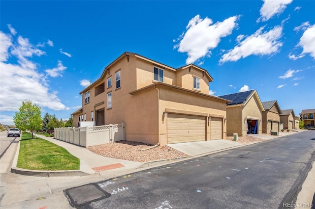 8913 Sunstone Dr, Colorado Springs, CO 80924 - view of side of home with a garage, stucco siding, and concrete driveway