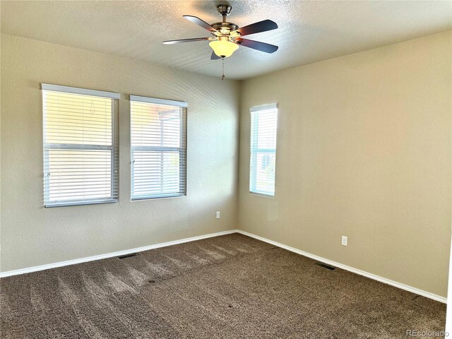 8913 Sunstone Dr, Colorado Springs, CO 80924 - spare room featuring a ceiling fan, dark colored carpet, baseboards, and a textured ceiling