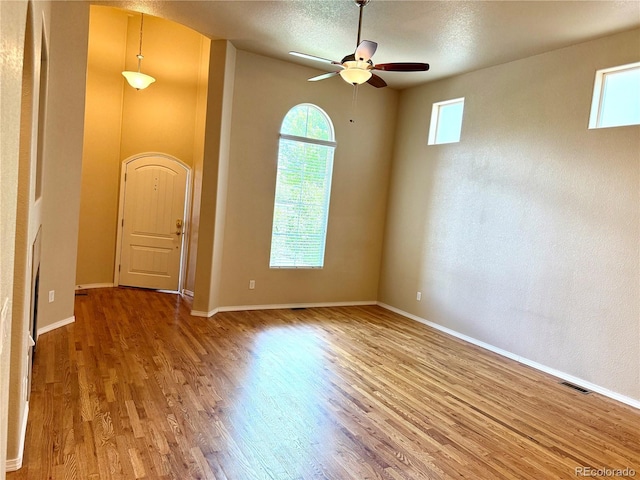 8913 Sunstone Dr, Colorado Springs, CO 80924 - spare room with wood finished floors, a ceiling fan, baseboards, and a textured ceiling