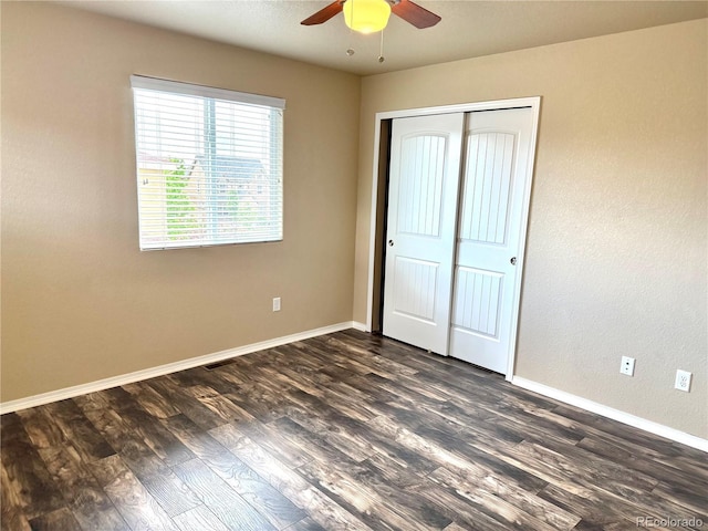 8913 Sunstone Dr, Colorado Springs, CO 80924 - unfurnished bedroom with dark wood-type flooring, a closet, baseboards, and a ceiling fan