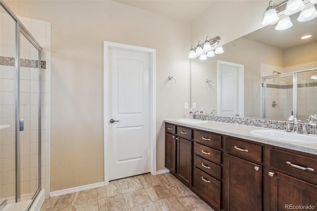8913 Sunstone Dr, Colorado Springs, CO 80924 - bathroom featuring a shower stall, double vanity, and baseboards