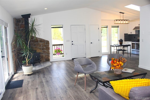 living room with a wood stove, a wealth of natural light, and dark hardwood / wood-style floors