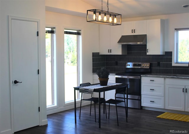 kitchen with dark wood-type flooring, ventilation hood, white cabinets, stainless steel electric range oven, and hanging light fixtures