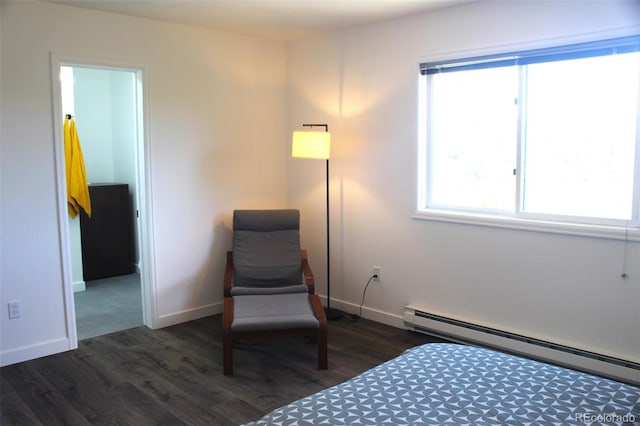 bedroom featuring baseboard heating and dark hardwood / wood-style flooring