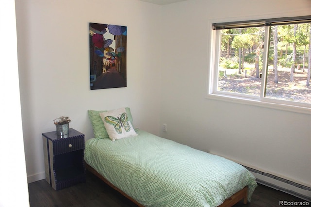 bedroom with dark wood-type flooring and a baseboard radiator