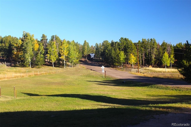 surrounding community featuring a rural view and a yard