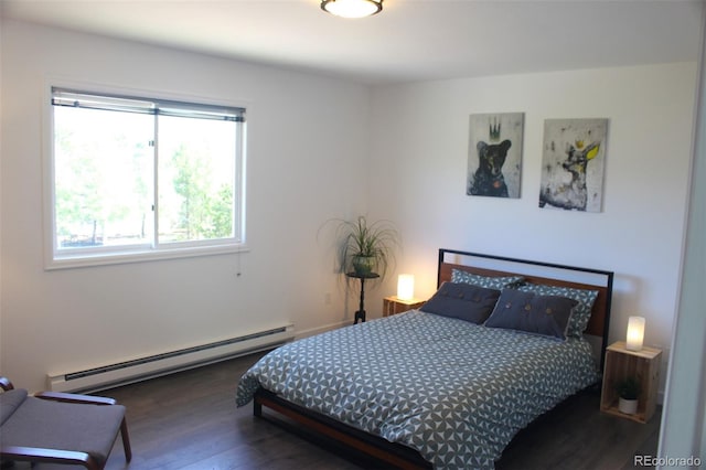 bedroom featuring dark wood-type flooring and a baseboard heating unit