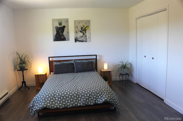 bedroom with a baseboard radiator, a closet, and dark wood-type flooring