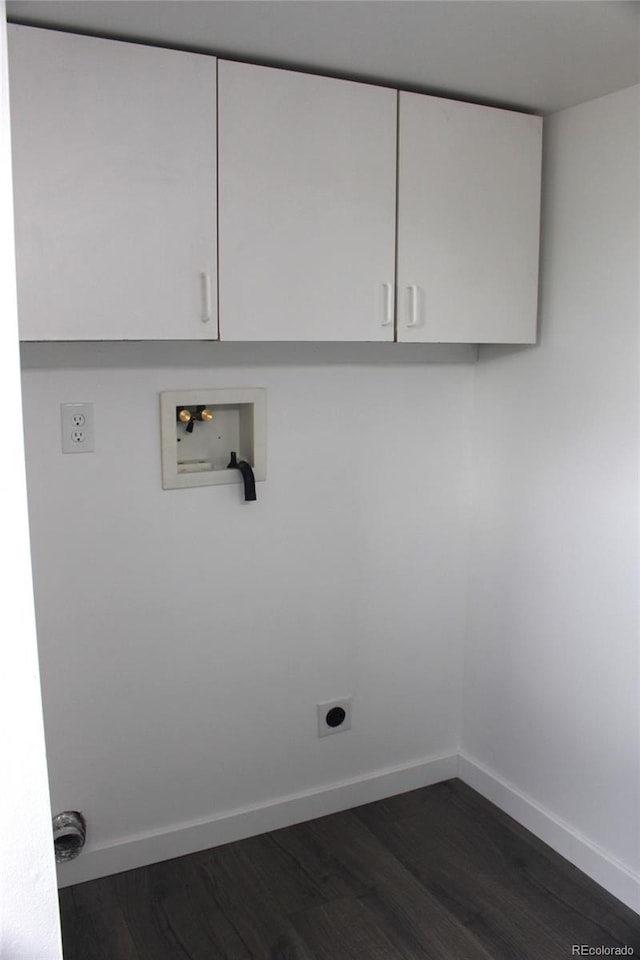 washroom with washer hookup, hookup for an electric dryer, dark wood-type flooring, and cabinets