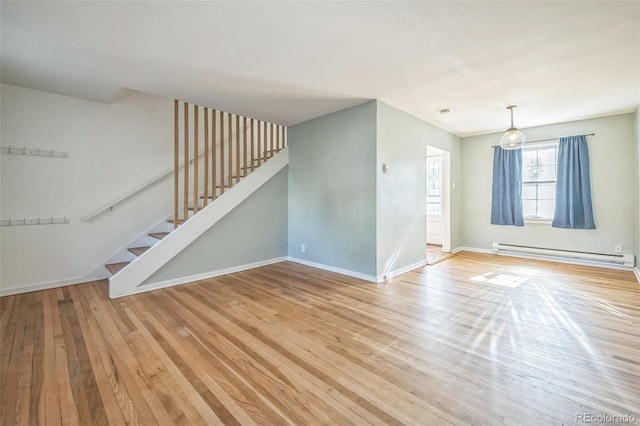 2858 Jasmine St, Denver, CO 80207 - unfurnished living room featuring a baseboard heating unit, light wood finished floors, stairs, and baseboards