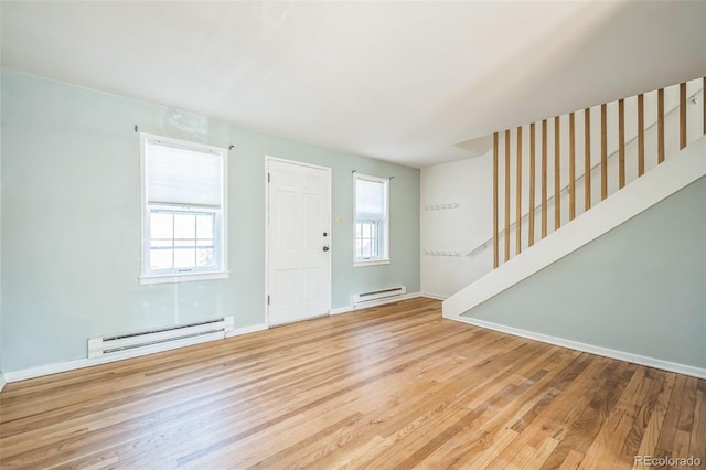 2858 Jasmine St, Denver, CO 80207 - foyer featuring baseboard heating, wood finished floors, stairway, and baseboards
