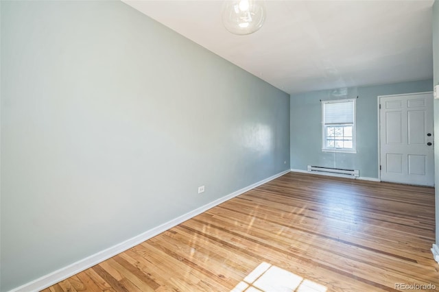 2858 Jasmine St, Denver, CO 80207 - unfurnished room with a baseboard radiator, light wood-type flooring, and baseboards