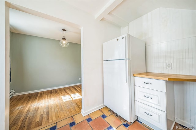 2858 Jasmine St, Denver, CO 80207 - kitchen featuring freestanding refrigerator, butcher block counters, baseboard heating, light wood-style floors, and white cabinetry