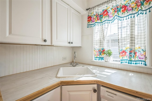 2858 Jasmine St, Denver, CO 80207 - kitchen featuring white dishwasher, a sink, light countertops, and white cabinetry