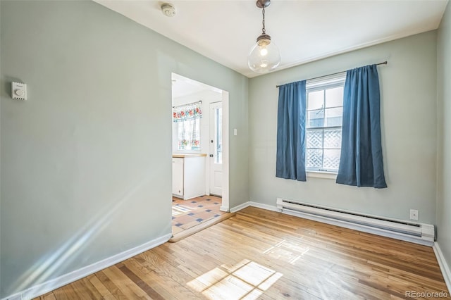 2858 Jasmine St, Denver, CO 80207 - empty room featuring baseboard heating, a smoke detector, plenty of natural light, and light wood finished floors