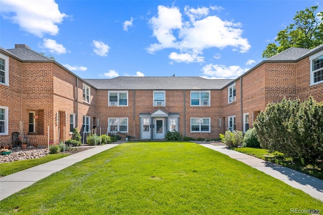 2858 Jasmine St, Denver, CO 80207 - view of property featuring a front lawn and brick siding