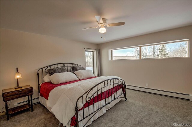 bedroom featuring a baseboard heating unit, ceiling fan, and carpet flooring